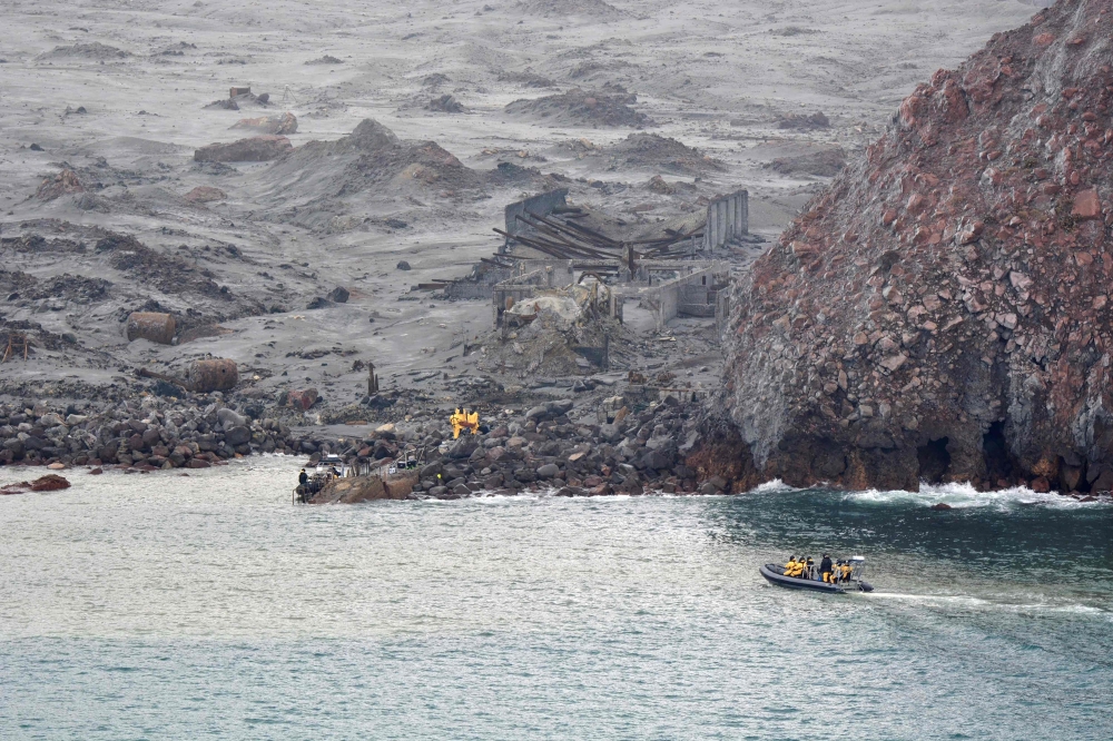 This handout photo taken on December 13, 2019 by the New Zealand Defence Force shows elite soldiers retrieving bodies from White Island after the December 9 volcanic eruption off Whakatane, North Island. — AFP pic