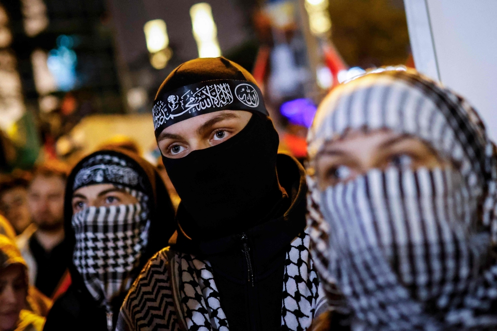 Demonstrators wearing keffiyeh take part in a rally in Istanbul on October 2, 2025, in solidarity with Palestinians and to condemn the interception of the Global Sumud Flotilla by the Israeli army. — AFP pic