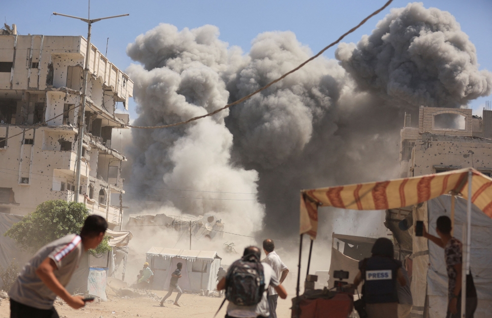 Smoke rises from an evacuated residential building which was housing displaced Palestinians, after it was hit by an Israeli air strike, in Gaza City September 14, 2025. — Reuters pic  