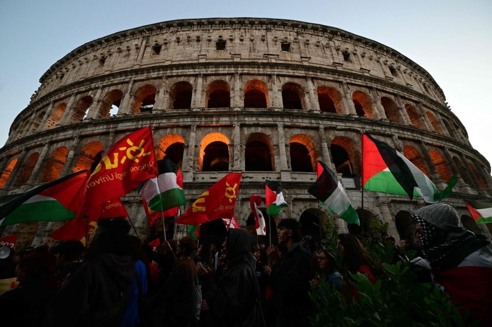 The strike, called by the USB and CGIL unions, follows demonstrations Thursday in several cities across the world, including in Milan and Rome, where some 10,000 people marched from the Colosseum. — AFP pic