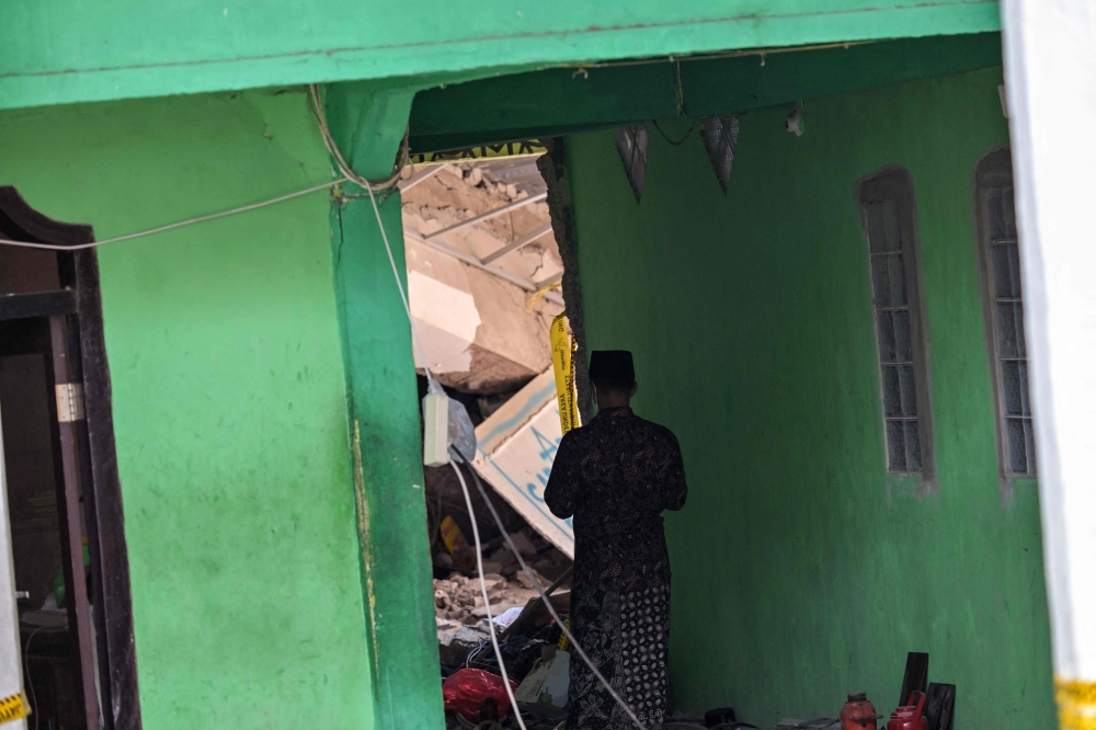 The death toll in an Indonesian school collapse rose to 10 on Friday, officials said, but dozens were still believed under the rubble without signs of life days after the disaster. — AFP pic