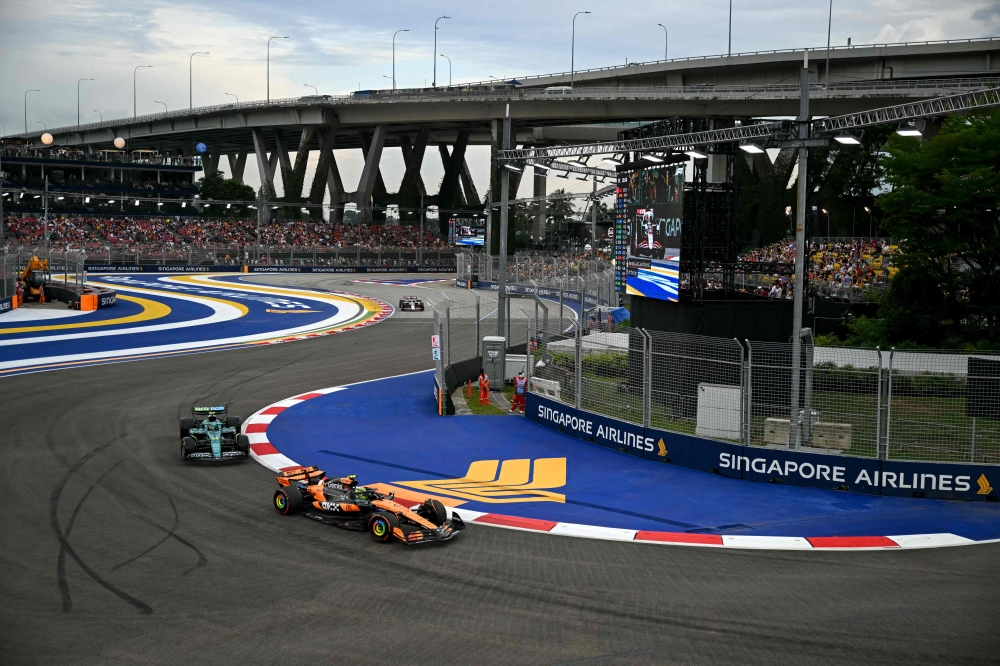 McLaren’s British driver Lando Norris (right) and Aston Martin’s Spanish driver Fernando Alonso drive during the first practice session ahead of the Formula One Singapore Grand Prix night race at the Marina Bay Street Circuit in Singapore on October 3, 2025. — AFP pic 