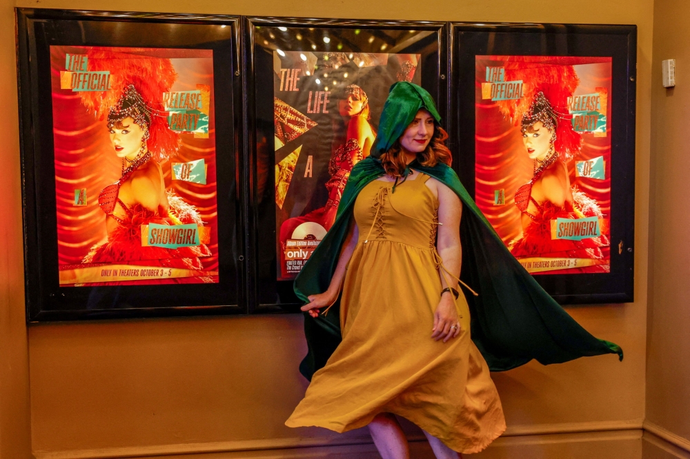 A fan wears an outfit inspired by The Eras Tour poses in front of ‘The Official Release Party of a Showgirl’ posters at an AMC theatre to celebrate the release of Taylor Swift’s new album ‘The Life of a Showgirl’ in New York October 3, 2025. — Reuters pic