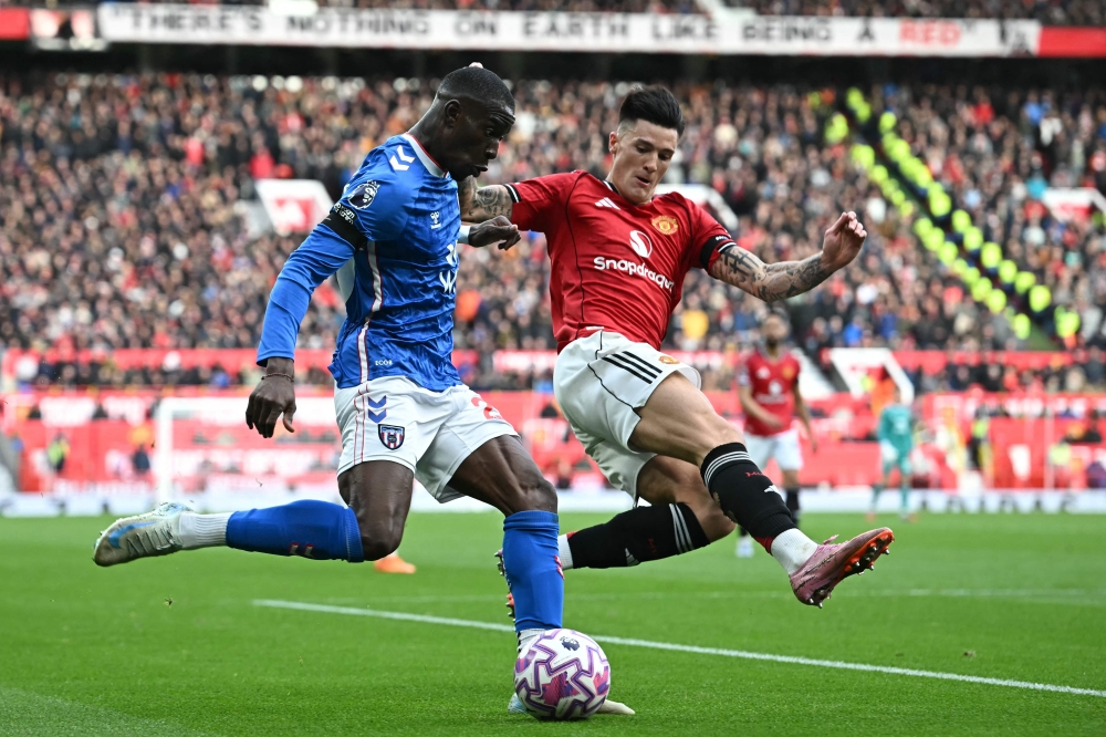 Sunderland’s Nordi Mukiele (left) vies with Manchester United’s Benjamin Sesko (right) during their Premier League match at Old Trafford in Manchester October 4, 2025. — AFP pic
