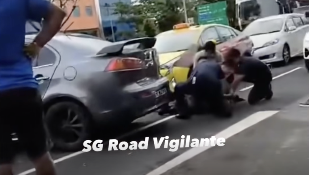 Police officers arrested fugitive gang leader Muhammad Idris Musbah after he was recognised while stuck in traffic, ending his year-long run. — Screengrab from Facebook/SG Road Vigilante