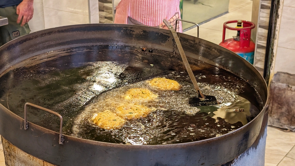 Not all kebabs are grilled; ‘chapli kebab’ and ‘shami kebab’ (pictured here) are minced patties that are shallow-fried in a large pan like this. — Picture by Ethan Lau