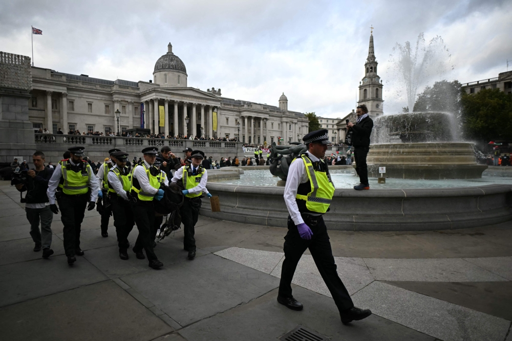 A protester is taken away by police officers at a ‘Lift The Ban’ demonstration in support of the proscribed group Palestine Action, calling for the recently imposed ban to be lifted, in London October 4, 2025. — AFP pic