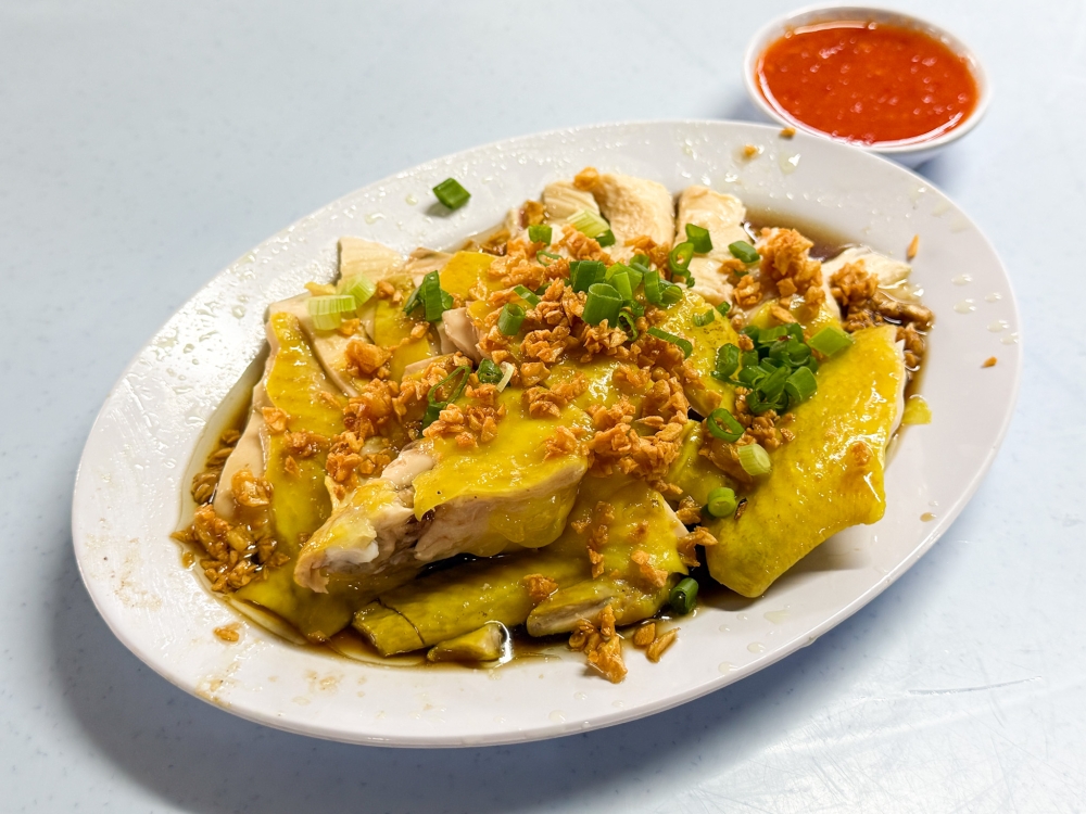 Poached chicken with lots of fried garlic is found on almost every table. — Picture by Lee Khang Yi