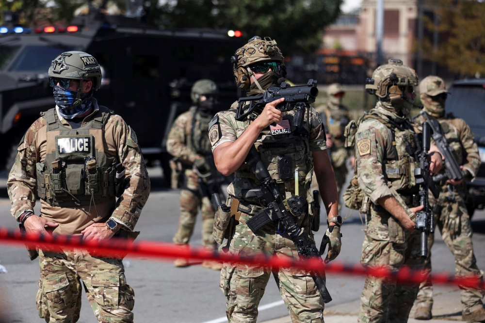 Law enforcement officers during a standoff with US Immigration and Customs Enforcement (ICE) and federal officers in the Little Village neighbourhood of Chicago, Illinois October 4, 2025. — Reuters pic 