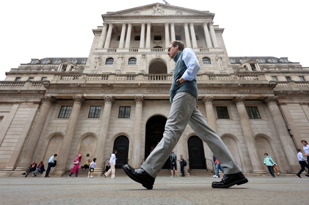 A man walks past the Bank of England building in London August 4, 2025. — Reuters pic