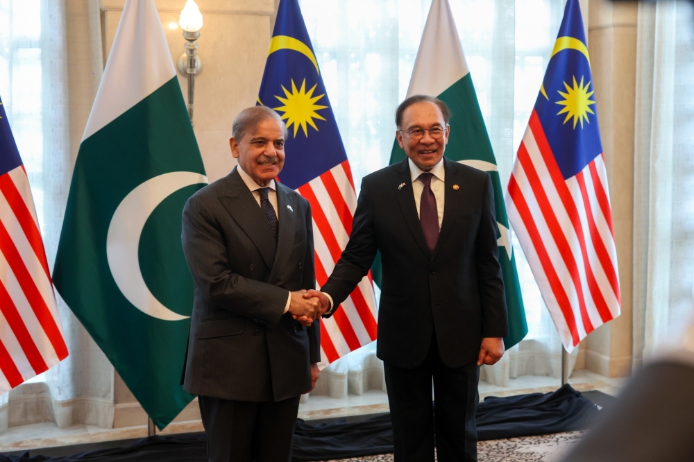 Prime Minister Datuk Seri Anwar Ibrahim with Pakistan Prime Minister Muhammad Shehbaz Sharif during a luncheon at the Seri Perdana Complex in Putrajaya, October 6, 2025. — Bernama pic 