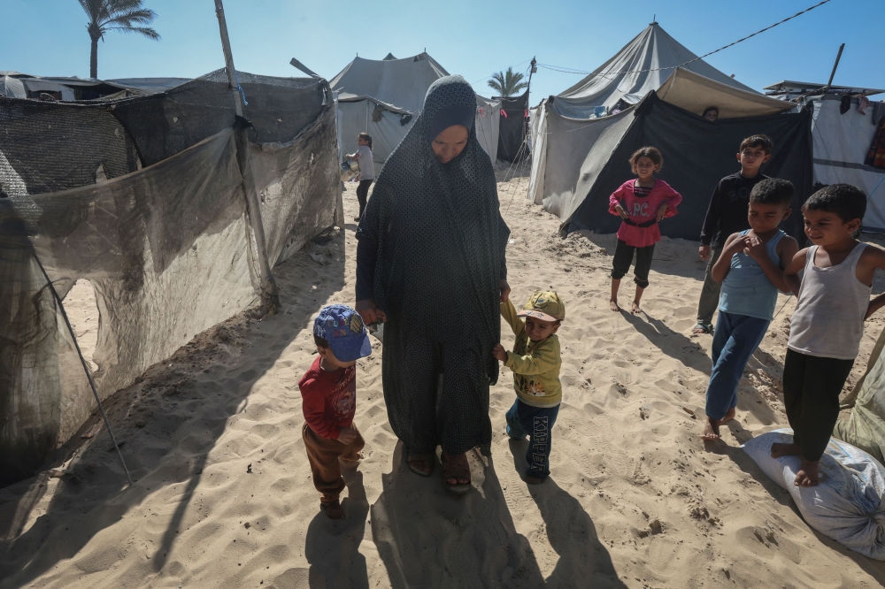 The twins live in a crowded beach encampment to a background of almost constant crying by the people around them, the shouting of street vendors, the menacing buzz of warplanes and the crackle of gunfire in the distance. — Reuters pic
