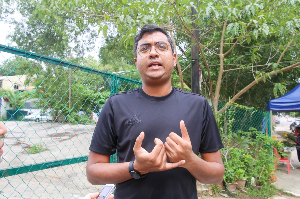 Protect Taman Desa volunteer Dishen Keseva Kumar said he wanted to add value with his skills to preserve the neighbourhood feel in Taman Desa. — Picture by Choo Choy May