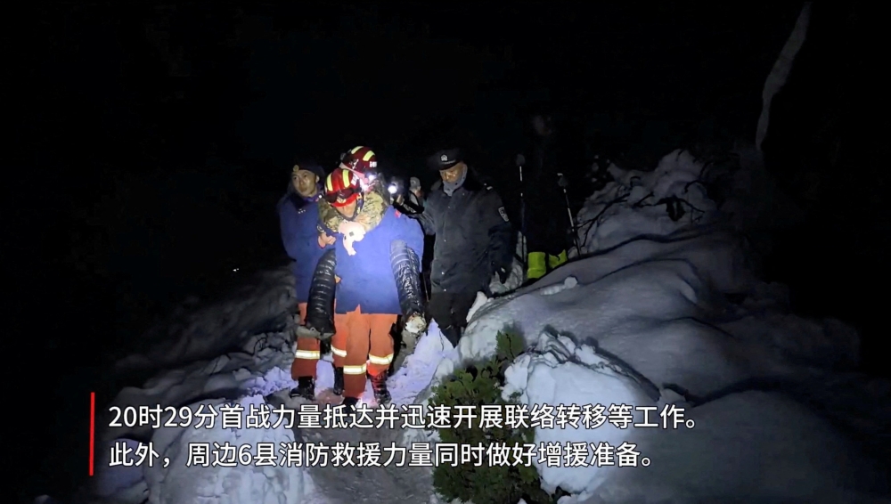 Tibetan firefighters rescue trekkers from Everest after they were stranded by a blizzard, in Tingri, Tibet Autonomous Region, China, in this screen grab taken from video released on October 6, 2025. — Tibet Firefighting Department handout via Reuters