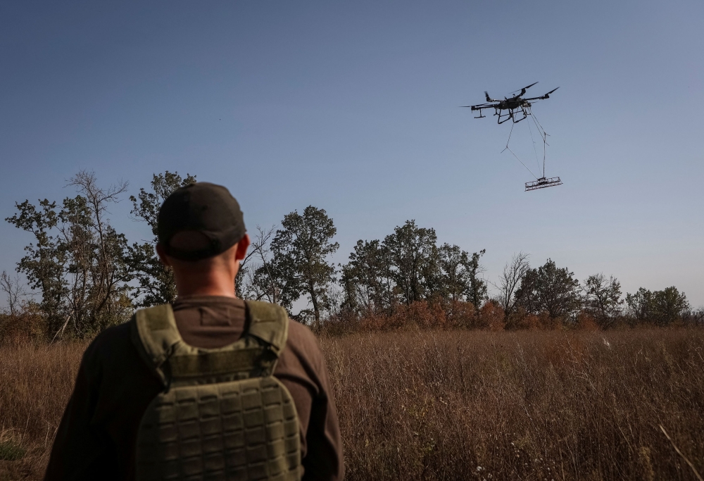 A member of the volunteer organization 'Postup' operates a drone with a metal detector for mine searching during demining a field, amid Russia's attack on Ukraine, near the town of Derhachi, Kharkiv region, Ukraine October 1, 2023. — Reuters file pic