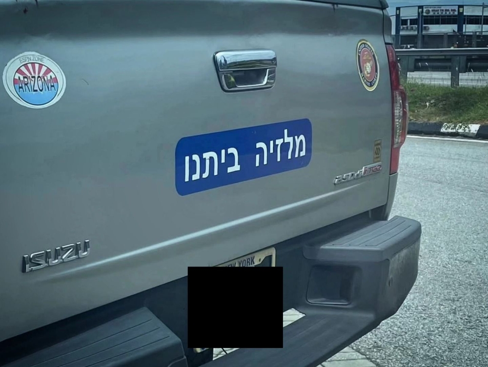 The sticker on the Isuzu pickup truck in Melaka that went viral online. — Picture via Facebook