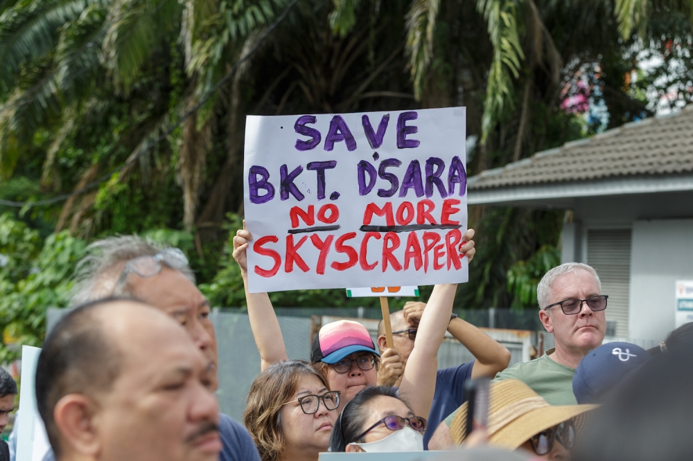 A protester holds a placard during the 'Save Bukit Damansara - Say No to Skyscrapers' protest at Damansara, Kuala Lumpur October 4, 2025. — Picture by Raymond Manuel