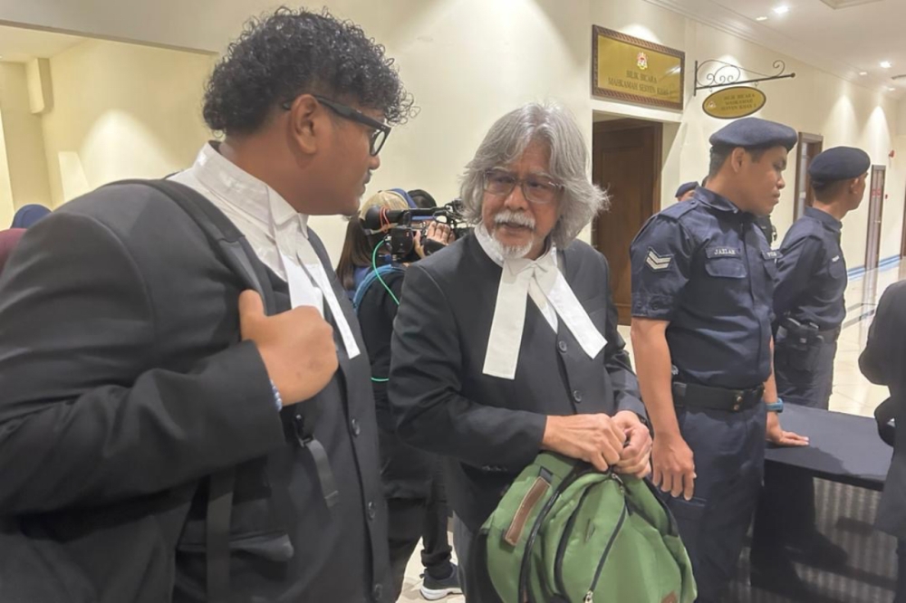 A 27-year-old engineer has been remanded for four days in connection with death threats sent to lawyer Datuk Ram Singh (centre), believed to be linked to the Zara Qairina Mahathir inquest. — Picture by Julia Chan