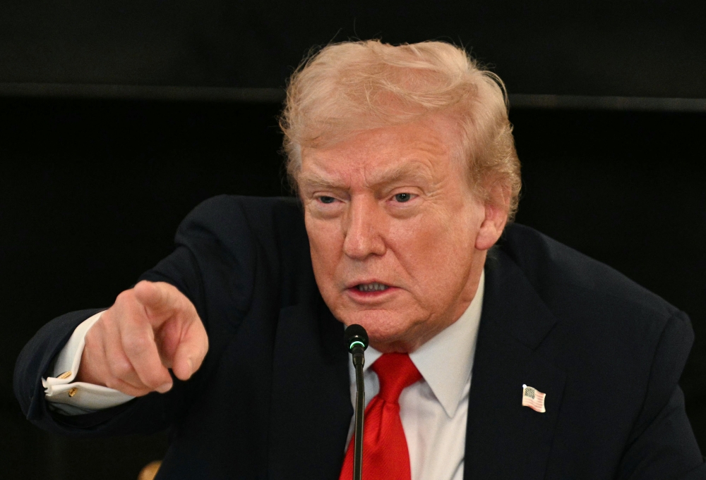 Donald Trump’s attacks on Chicago Mayor Brandon Johnson and Illinois Governor JB Pritzker, both Democrats, follow similar extraordinary public calls by the president for his political opponents to face legal charges. — AFP pic