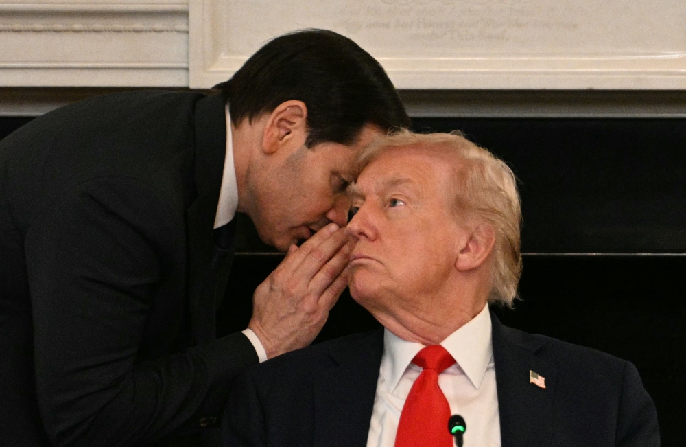 US Secretary of State Marco Rubio whispers in the ear of President Donald Trump during a roundtable about Antifa in the State Dining Room of the White House in Washington. — AFP pic