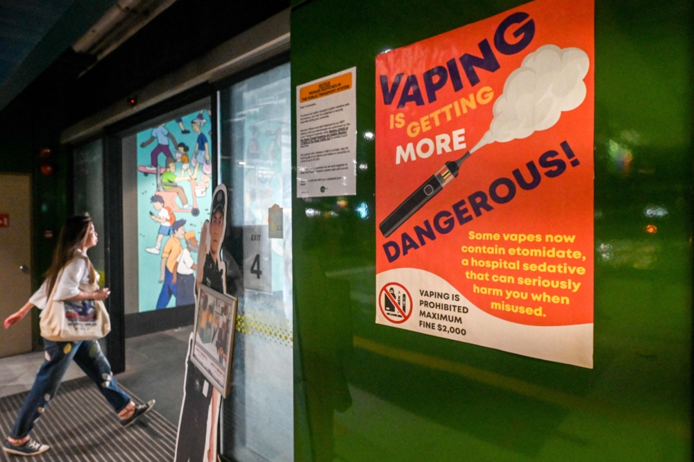 This photograph taken on September 17, 2025 shows a poster warning against the danger of using vapes at a bus terminal in Singapore. — AFP pic