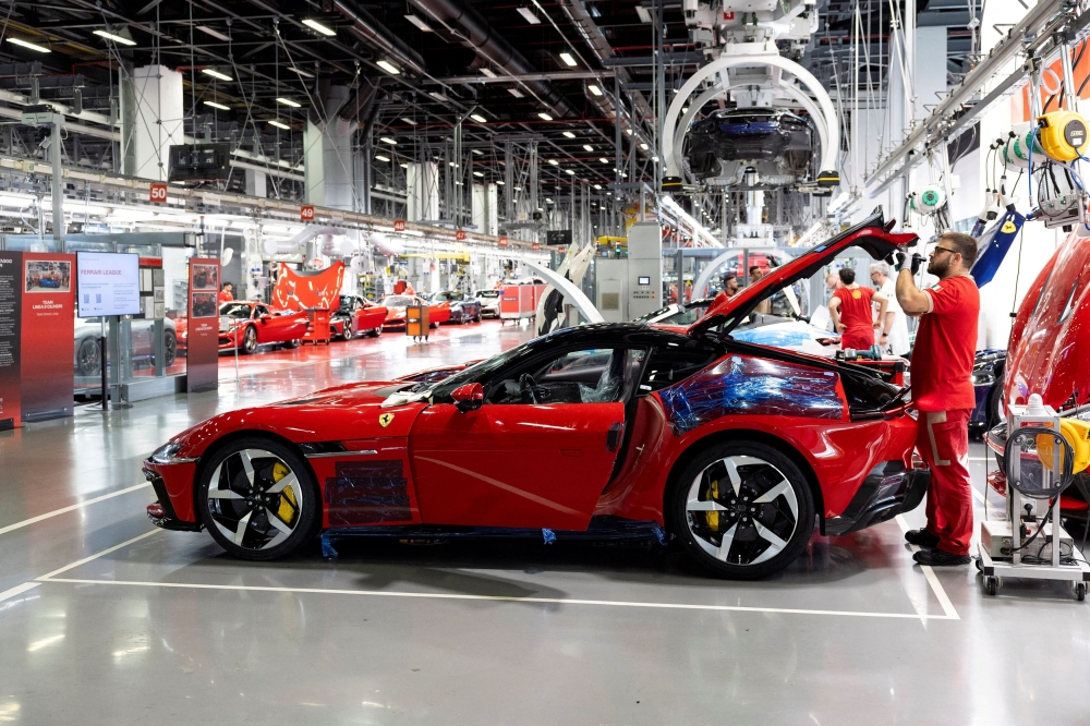 A Ferrari worker inspects a car inside the company’s factory in Maranello, Italy, October 2, 2025. — Reuters pic 