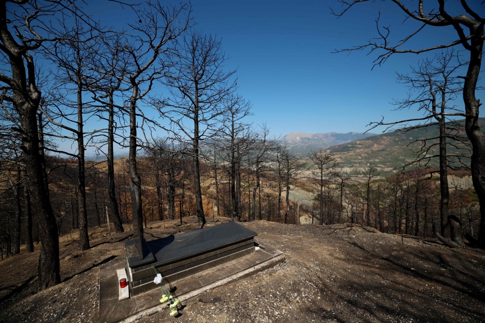 This photograph shows a grave at a cemetery in a burned forest, in Skenderbegas, near Gramsh September 16, 2025. — AFP pic