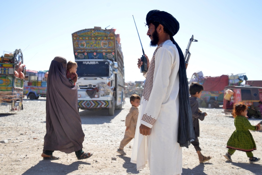 A Taliban security personnel stands guard as Afghans deported from Pakistan arrive at a registration centre at Takhta Pul in Kandahar province October 9, 2025. — AFP pic 