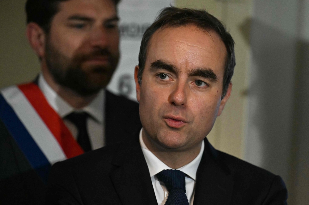 France's Prime Minister Sebastien Lecornu meets with officials during a visit to a police station in L'Hay-les-Roses, on the southern outskirts of Paris on October 11, 2025. — Martin Lelievre/Pool/AFP pic
