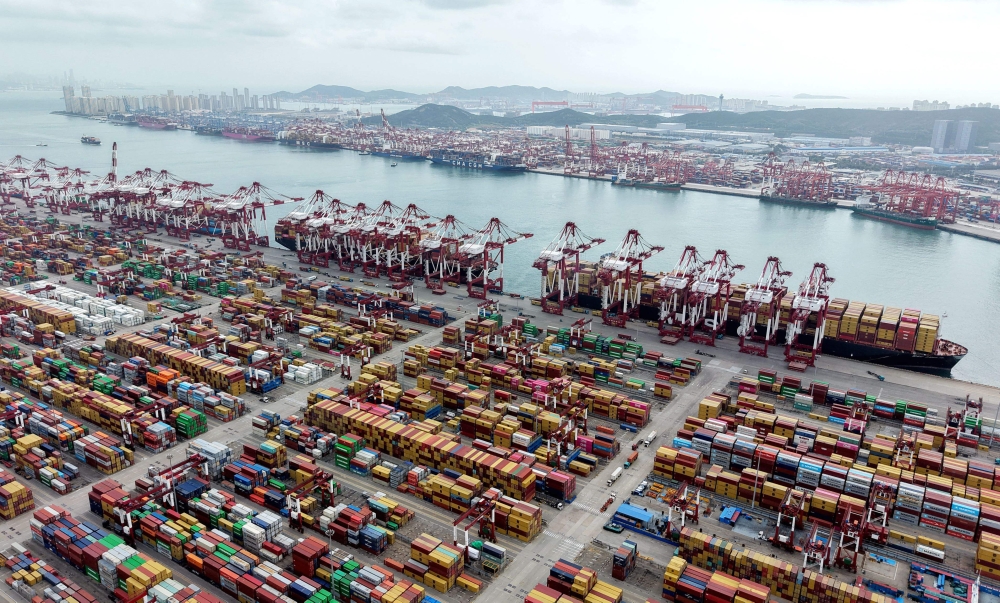 Ships are berthed at the container terminal of the port in Qingdao, in China’s eastern Shandong province on October 9, 2025. US President Donald Trump announced an additional 100 percent tariff on China yesterday and threatened to cancel a summit with Xi Jinping, reigniting his trade war with Beijing in a row over export curbs on rare earth minerals. — AFP pic
