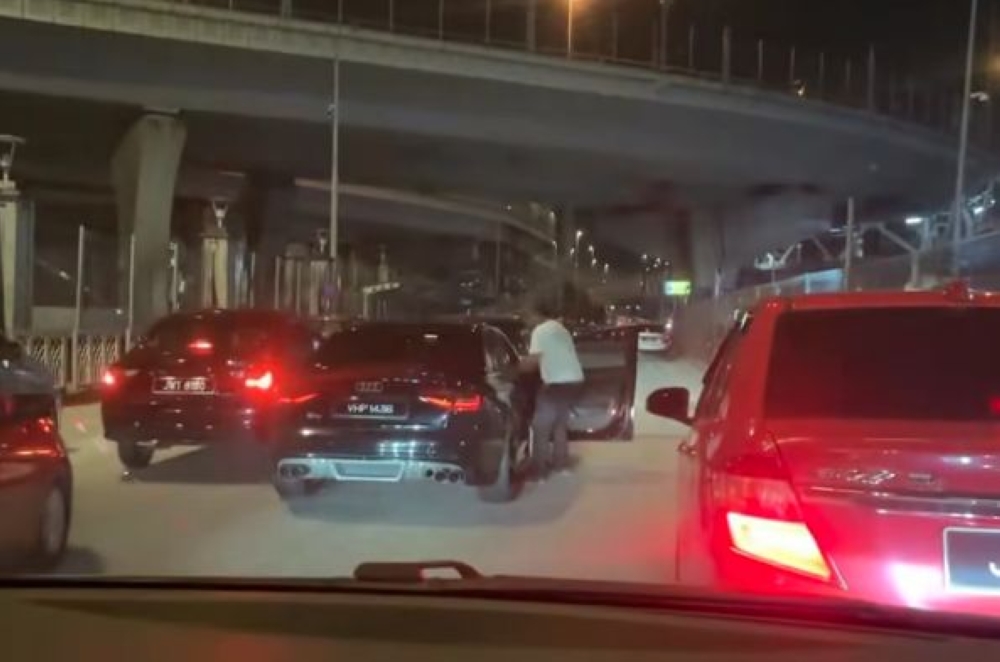 A still shows two people in an altercation near the Sultan Ibrahim Customs Complex.