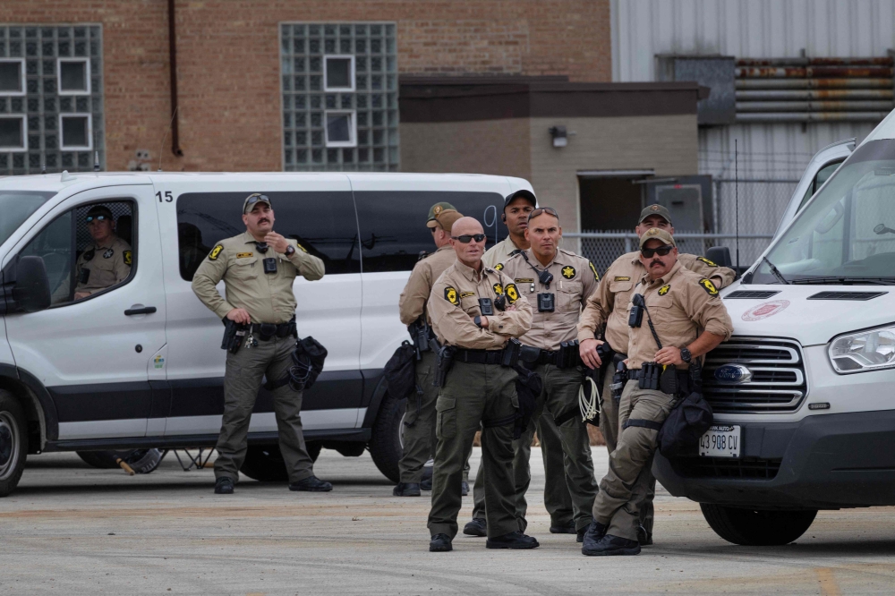 Police stand guard as US Senators Dick Durbin and Tammy Duckworth meet with demonstrators outside an immigration processing and detention facility in Broadview, Illinois, on October 10, 2025. — AFP pic