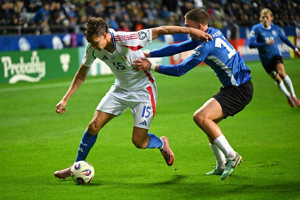 Italy’s forward Pio Esposito (left) challenges Estonia’s defender Maksim Paskotsi for the ball during their FIFA World Cup 2026 Group I European qualifier in Tallinn, Estonia, on October 11, 2025. — AFP pic