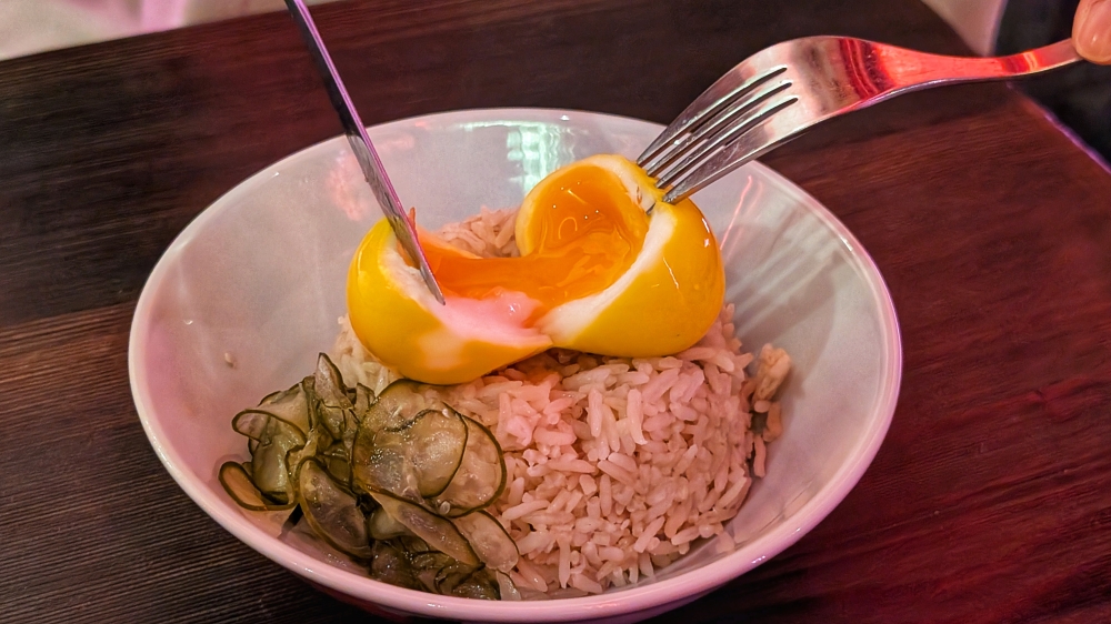The chicken rice bowl is surprisingly flavourful, with a jammy egg on top of rice enriched with chicken fat, ginger and scallions. — Picture by Ethan Lau