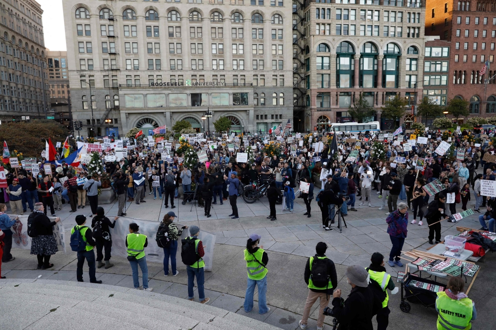 People gather to protest the arrival of the Texas National Guard and US Immigration and Customs Enforcement agents in downtown Chicago, Illinois, on October 8, 2025. Chicago, the third-largest in the country, has become the latest flashpoint in a crackdown by US Immigration and Customs Enforcement (ICE) agents that has sparked allegations of rights abuses and myriad lawsuits. — AFP pic