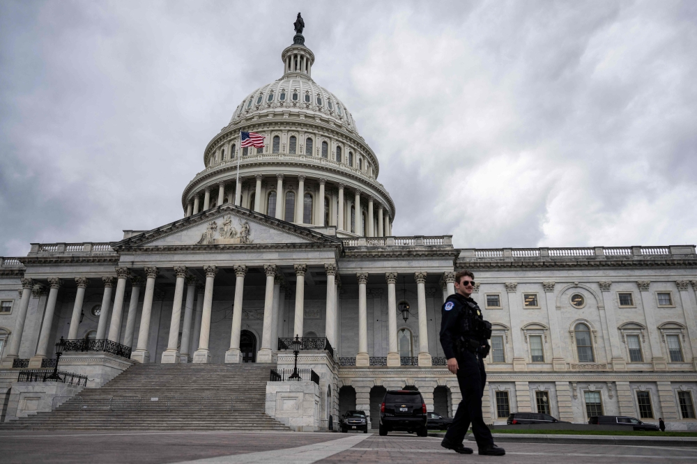 Capitol police patrol around the US Capitol on the 8th day of the government shutdown on October 8, 2025 in Washington, DC. White House budget director Russell Vought, who has been credited as the mastermind behind the drive to slash the federal workforce, has bragged about causing ‘traumas’ among civil servants. — AFP pic 
