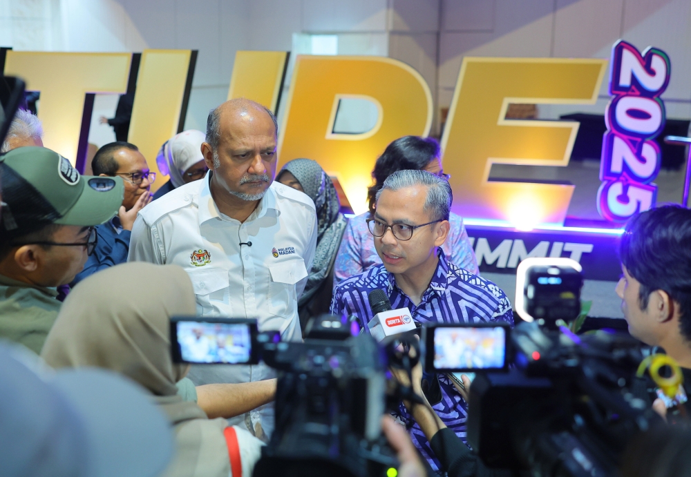 Communications Minister Datuk Fahmi Fadzil (right) answers questions from the media after attending the International Young Future Leaders Summit (iFUTURE) 2025 at Dewan Merdeka, World Trade Centre Kuala Lumpur today. — Bernama pic 