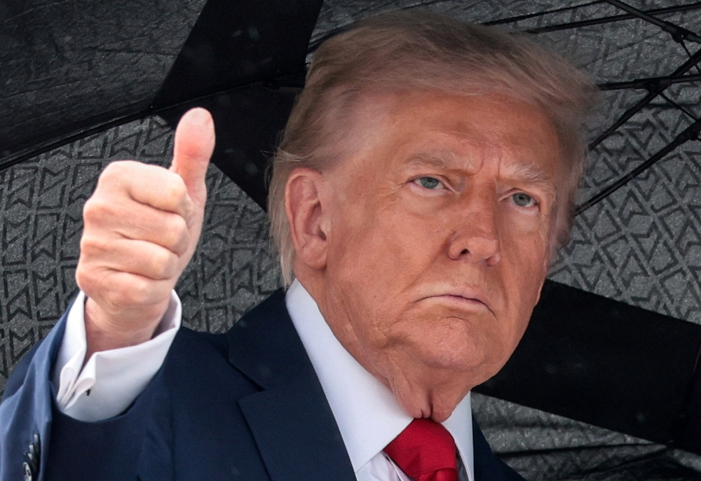 US President Donald Trump gives a thumbs up while boarding Air Force One, as he departs for Israel, at Joint Base Andrews, Maryland October 12, 2025. — Reuters pic