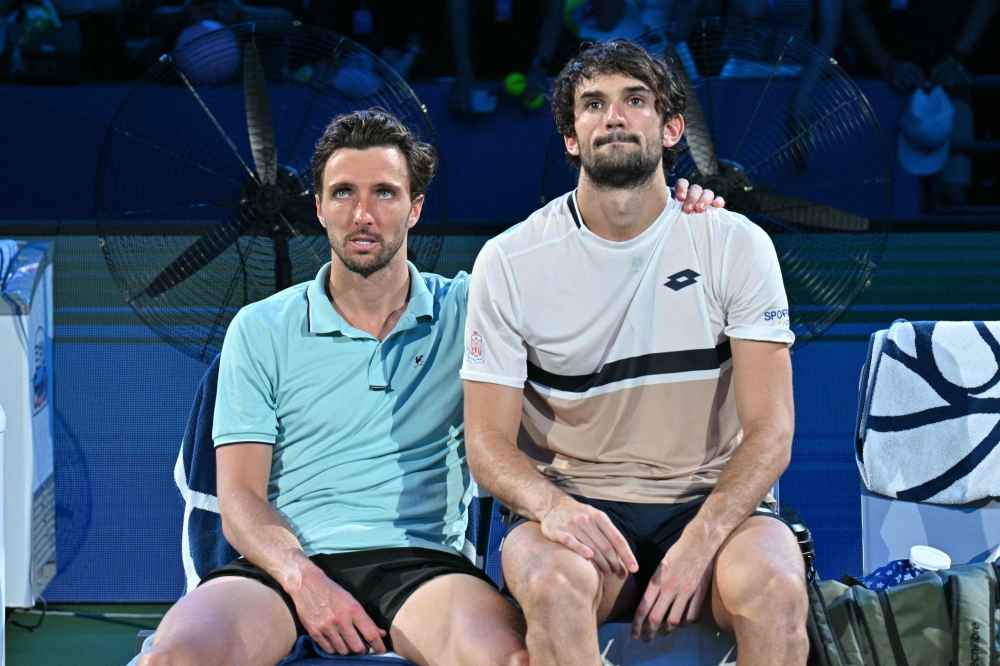 (From left) France’s Arthur Rinderknech and Monaco’s Valentin Vacherot sit together after Vacherot’s victory during the men’s singles final at the Shanghai Masters tennis tournament in Shanghai on October 12, 2025. — AFP pic