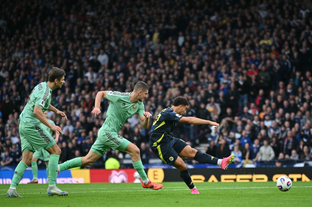 Scotland's striker #10 Che Adams shoots to score the opening goal during the 2026 World Cup Group C qualifier football match between Scotland and Belarus, at Hampden Park Stadium, in Glasgow October 12, 2025. — AFP pic 
