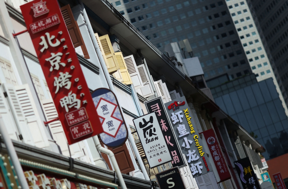 Signboards of restaurants selling Chinese cuisine at Liang Seah Street in central Singapore October 10, 2025. — Reuters pic