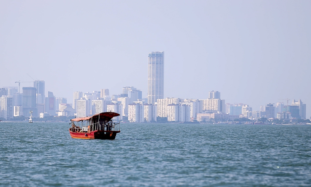 A boat crosses the Strait of Penang with Komtar visible in the background January 13, 2019. — Picture by Sayuti Zainudin