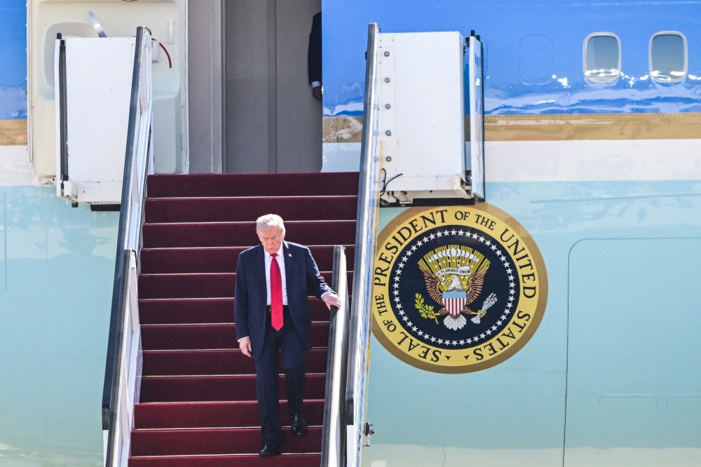 US President Donald Trump disembarks from Air Force One at Ben Gurion International airport, on the day Israeli hostages are released by Hamas and Palestinian prisoners by Israel after a ceasefire went into effect under the first phase of a US-brokered agreement, in Lod, Israel October 13, 2025. — Reuters pic