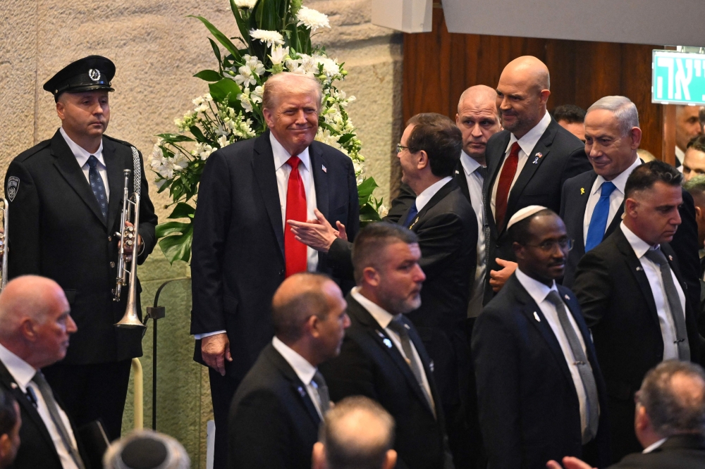 US President Donald Trump arrives to speak at the Israeli parliament, the Knesset, in Jerusalem October 13, 2025. Hamas handed over 20 surviving Israeli hostages under a ceasefire deal brokered by Trump, with Israel set to release nearly 2,000 detainees in exchange. — AFP pic