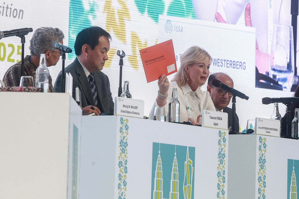 Swedish Pension Agency director general Anna Pettersson Westerberg is seen here with the 'orange envelope' sent out to Swedes annually with information on their pension savings and forecast of their future pension, although 75 per cent are now sent digitally. — Picture by Sayuti Zainudin