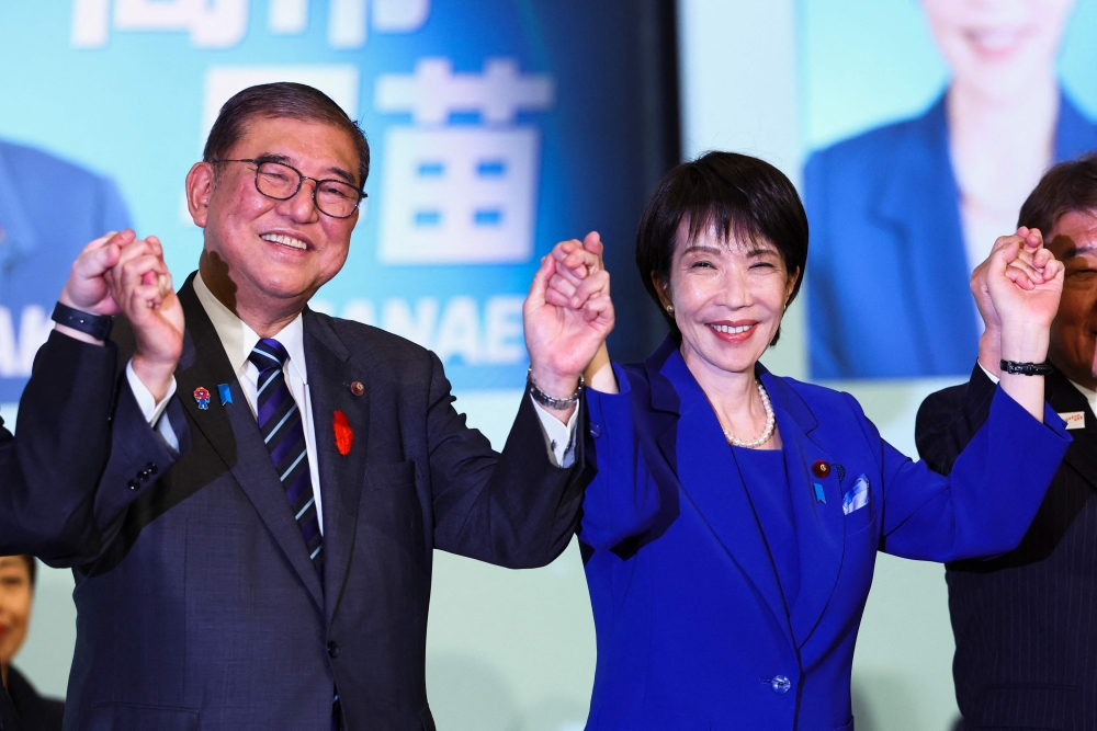 File picture of newly-elected leader of Japan’s Liberal Democratic Party (LDP) Sanae Takaichi (right) celebrates with Prime Minister Shigeru Ishiba after winning the LDP leadership election in Tokyo on October 4, 2025. Takaichi said the collapse of the country’s ruling coalition on October 10, 2025 was ‘extremely regrettable’, with her bid to become the country’s first woman prime minister in peril. — AFP pic 