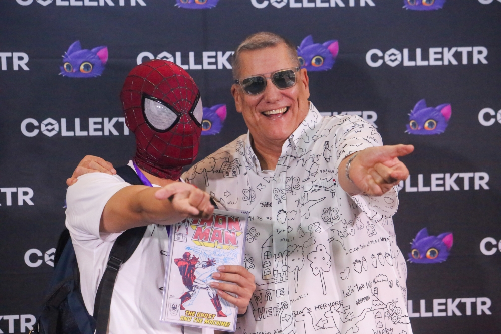 Bob Layton poses with a fan wearing a Spider-Man mask. — Picture by Choo Choy May