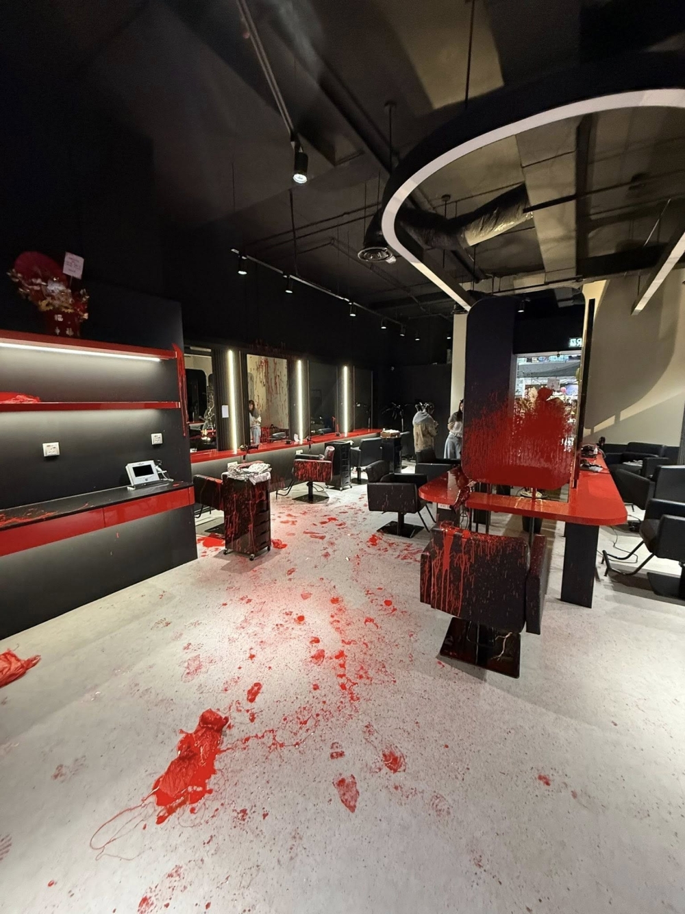 A widely shared image showing the salon’s interior defaced with red paint.