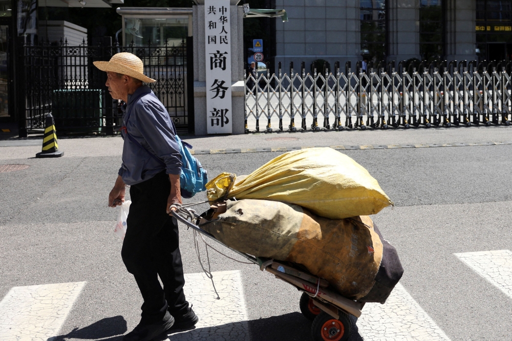 A man pulls a cart past the Chinese Ministry of Commerce building in Beijing, China June 4, 2025. — Reuters pic