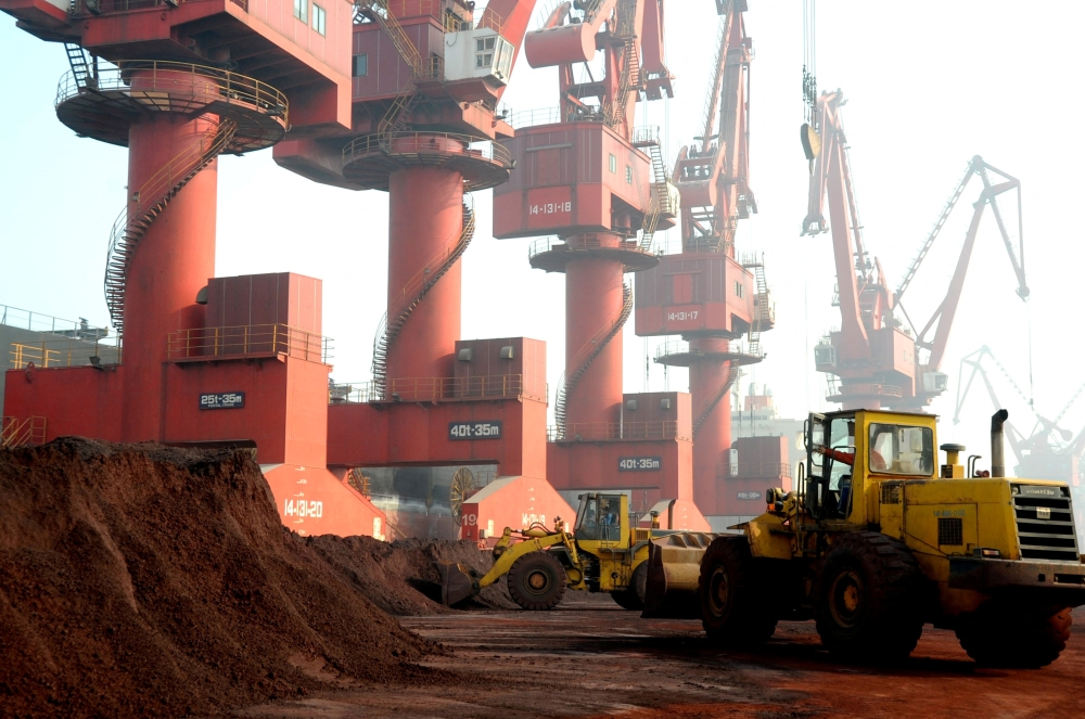 Workers transport soil containing rare earth elements for export at a port in Lianyungang, Jiangsu province, China, October 31, 2010. — Reuters pic
